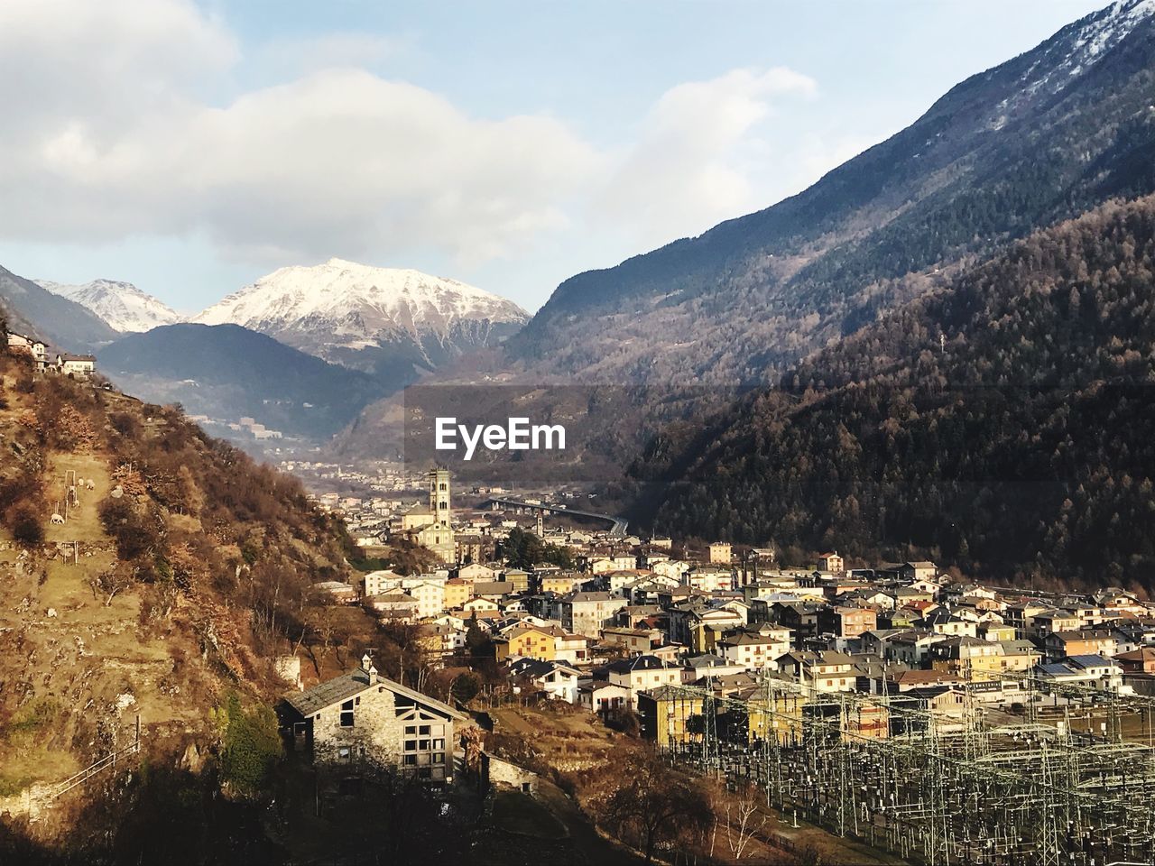 High angle view of townscape and mountains against sky