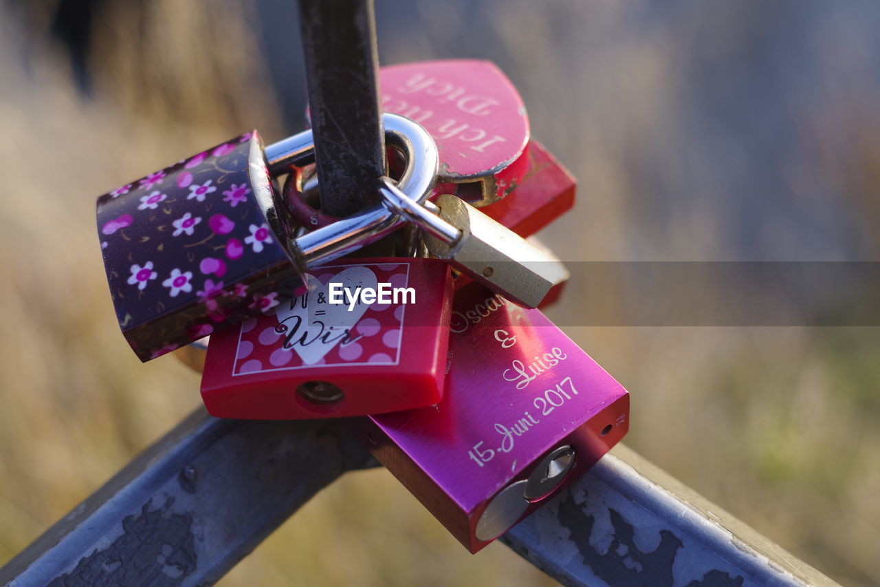 Close-up of padlocks hanging on railing