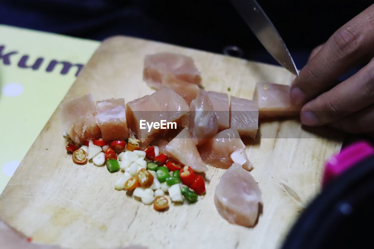 food, food and drink, hand, one person, freshness, indoors, cutting board, healthy eating, kitchen knife, cuisine, holding, close-up, selective focus, wellbeing, preparing food, cutting, dish, table, adult, lifestyles, vegetable