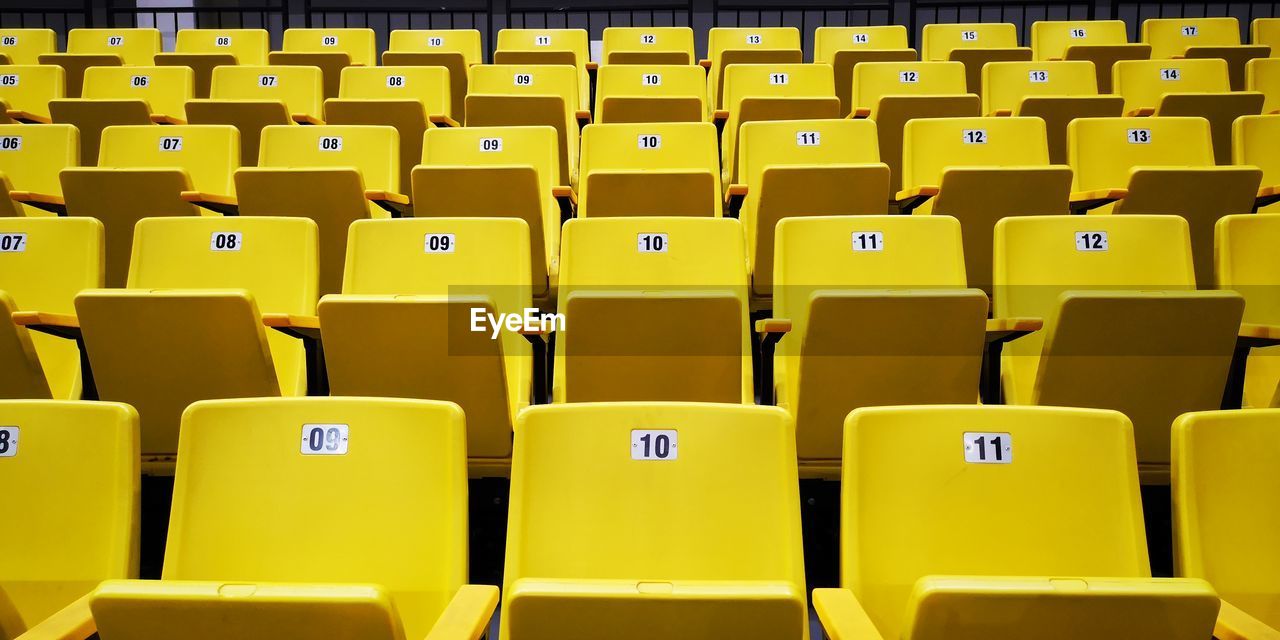Full frame shot of yellow empty bleachers at stadium