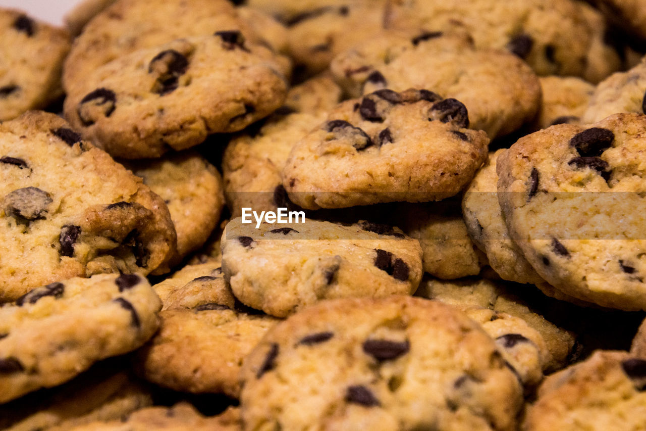 FULL FRAME SHOT OF CHOCOLATE COOKIES IN SAND