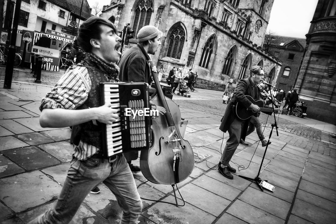 FULL LENGTH OF CHILD PLAYING WITH CITY IN BACKGROUND