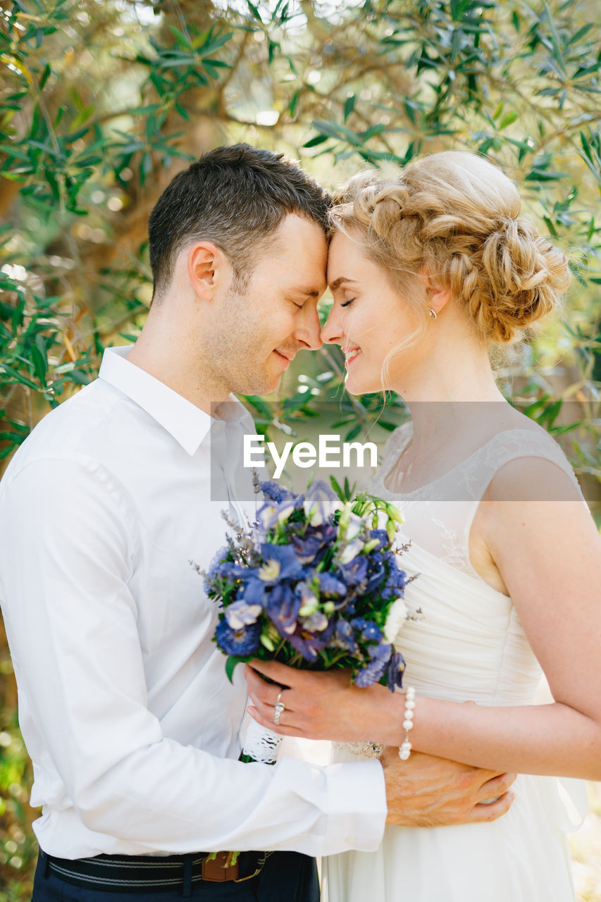 Side view of couple embracing outdoors