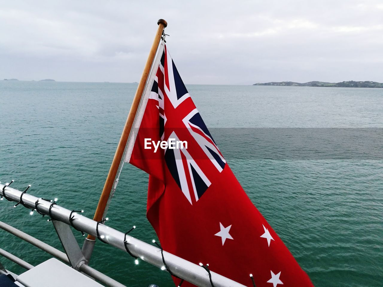 CLOSE-UP OF FLAG AGAINST BLUE SEA