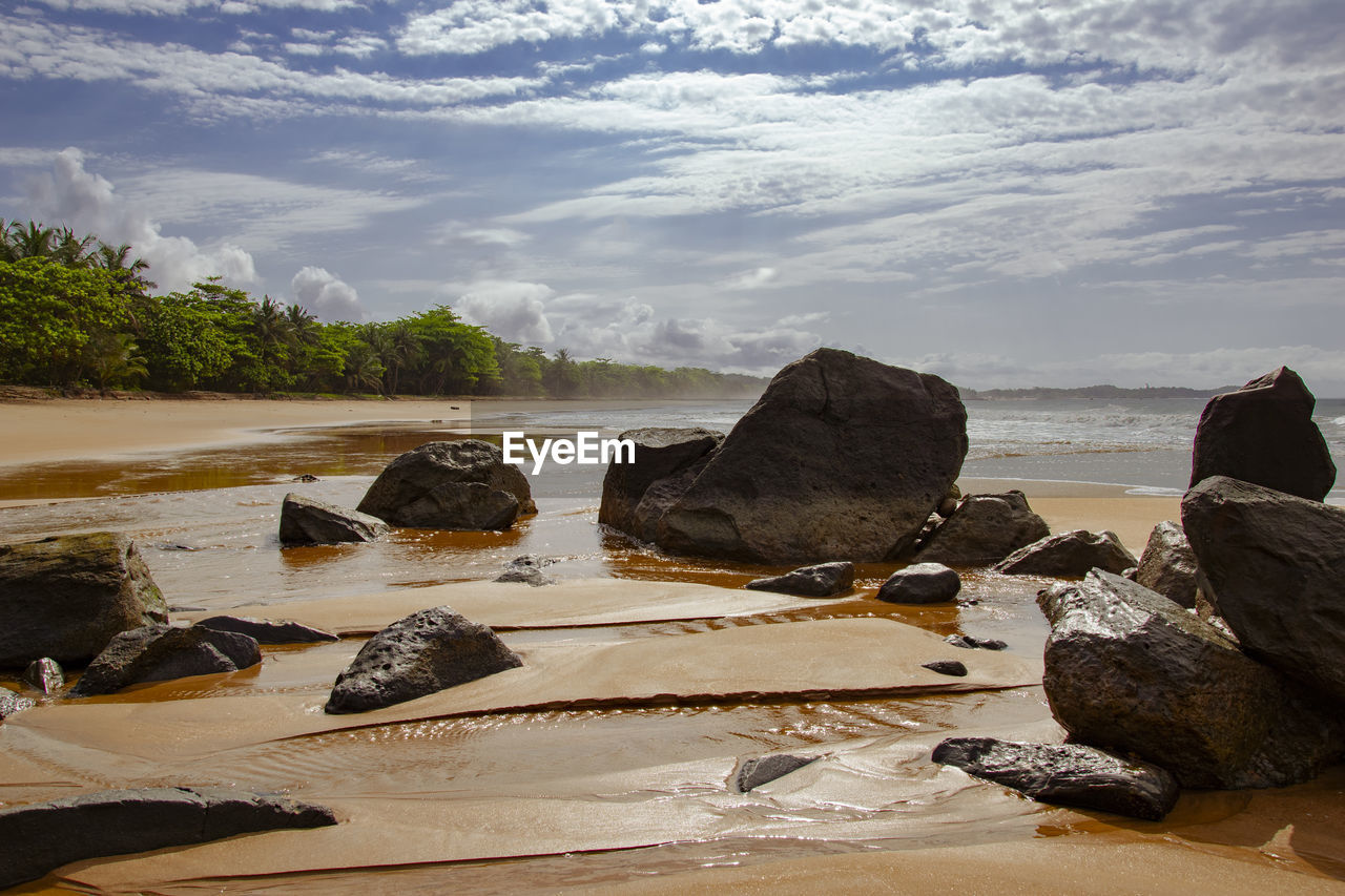 Rocks on beach against sky