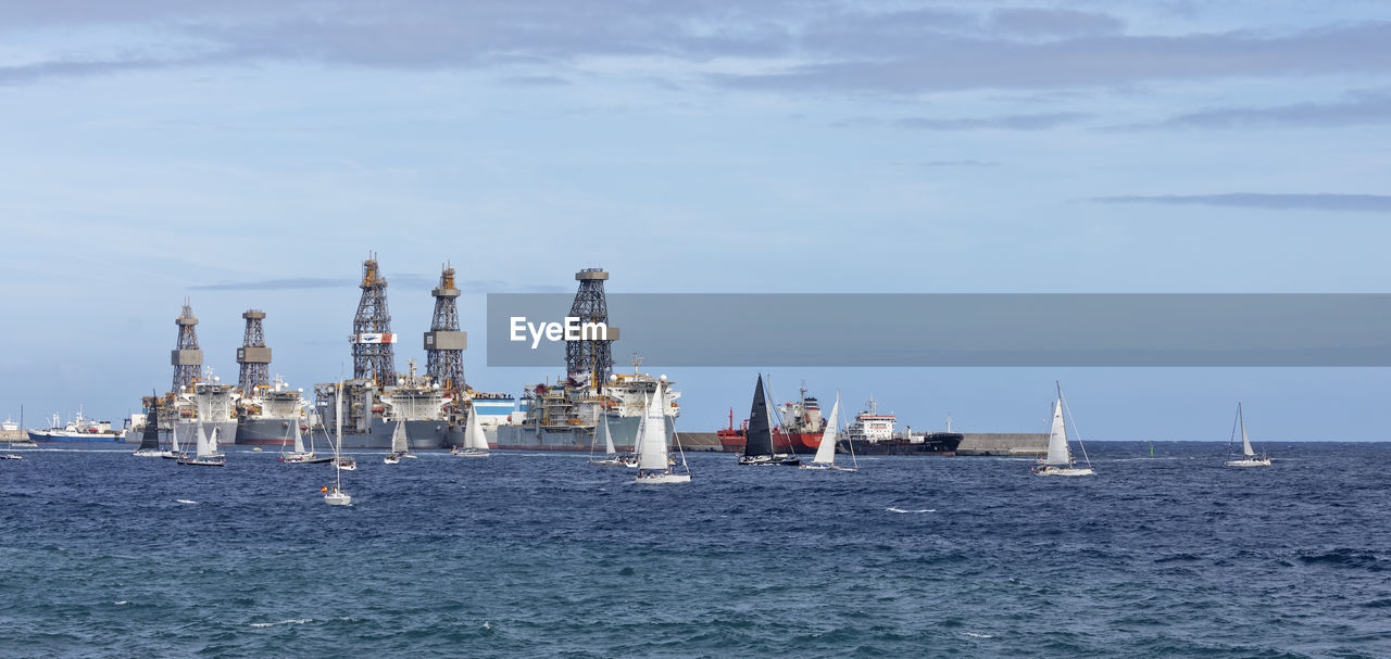 water, sea, nautical vessel, transportation, vehicle, sky, nature, industry, ship, oil industry, mode of transportation, watercraft, cloud, no people, day, power generation, outdoors, offshore drilling, boat, ocean, offshore platform, architecture, waterfront, horizon over water, sailboat, destroyer