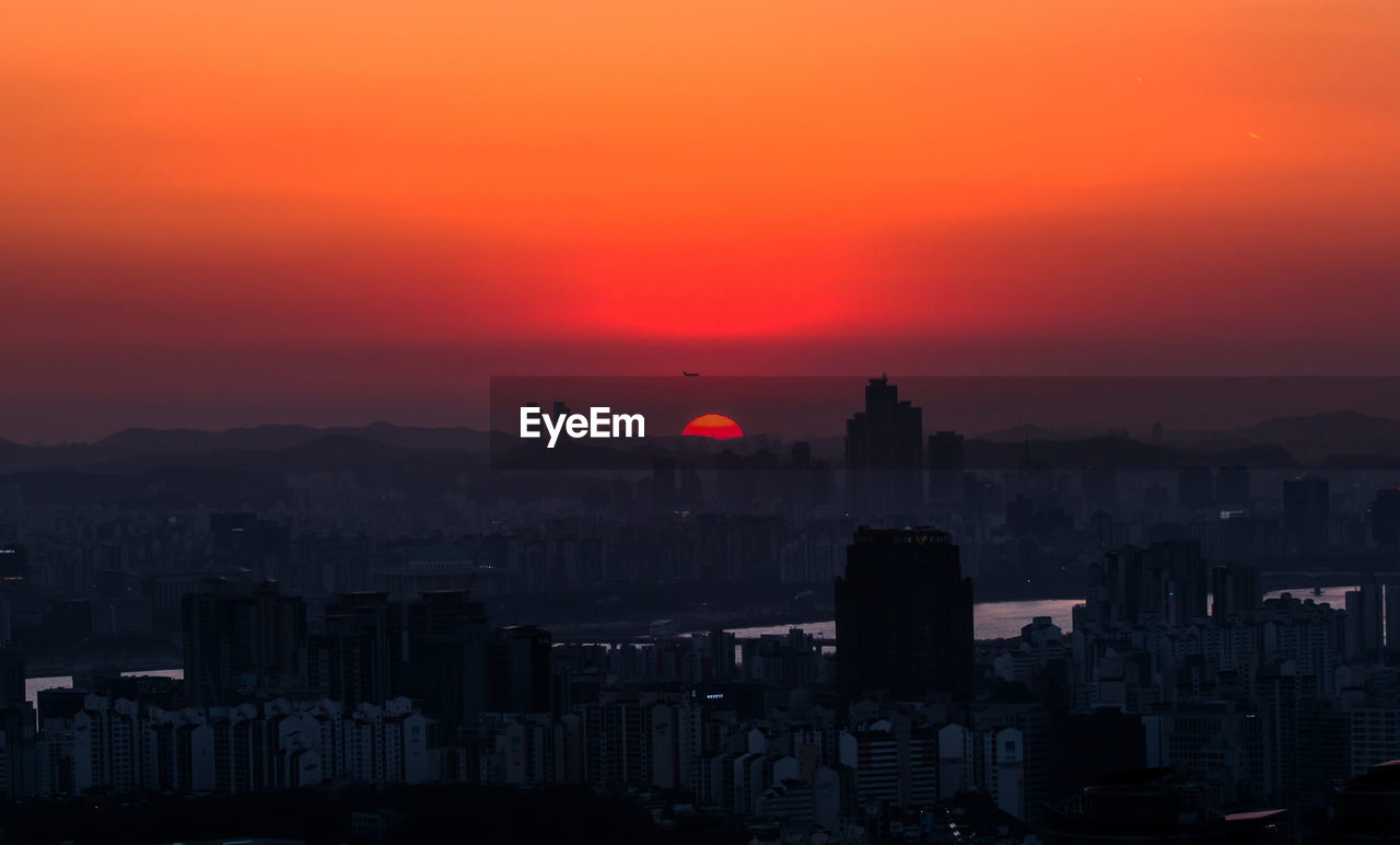 High angle view of cityscape against orange sky