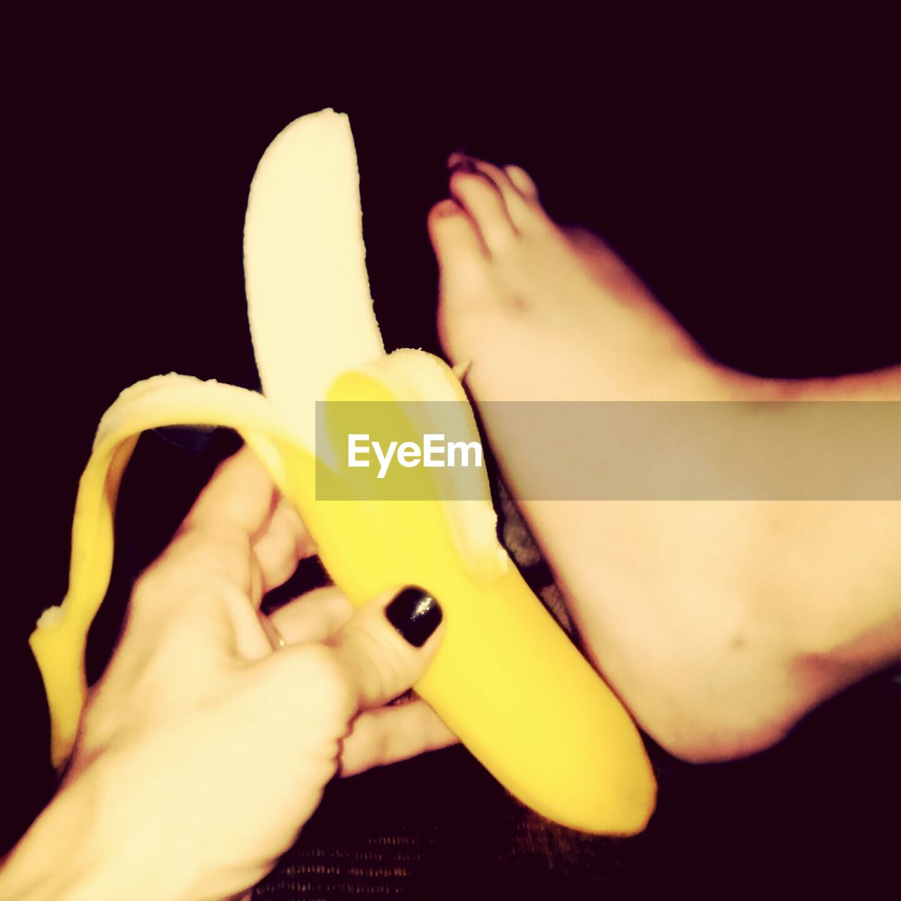 Close-up of human hand holding banana