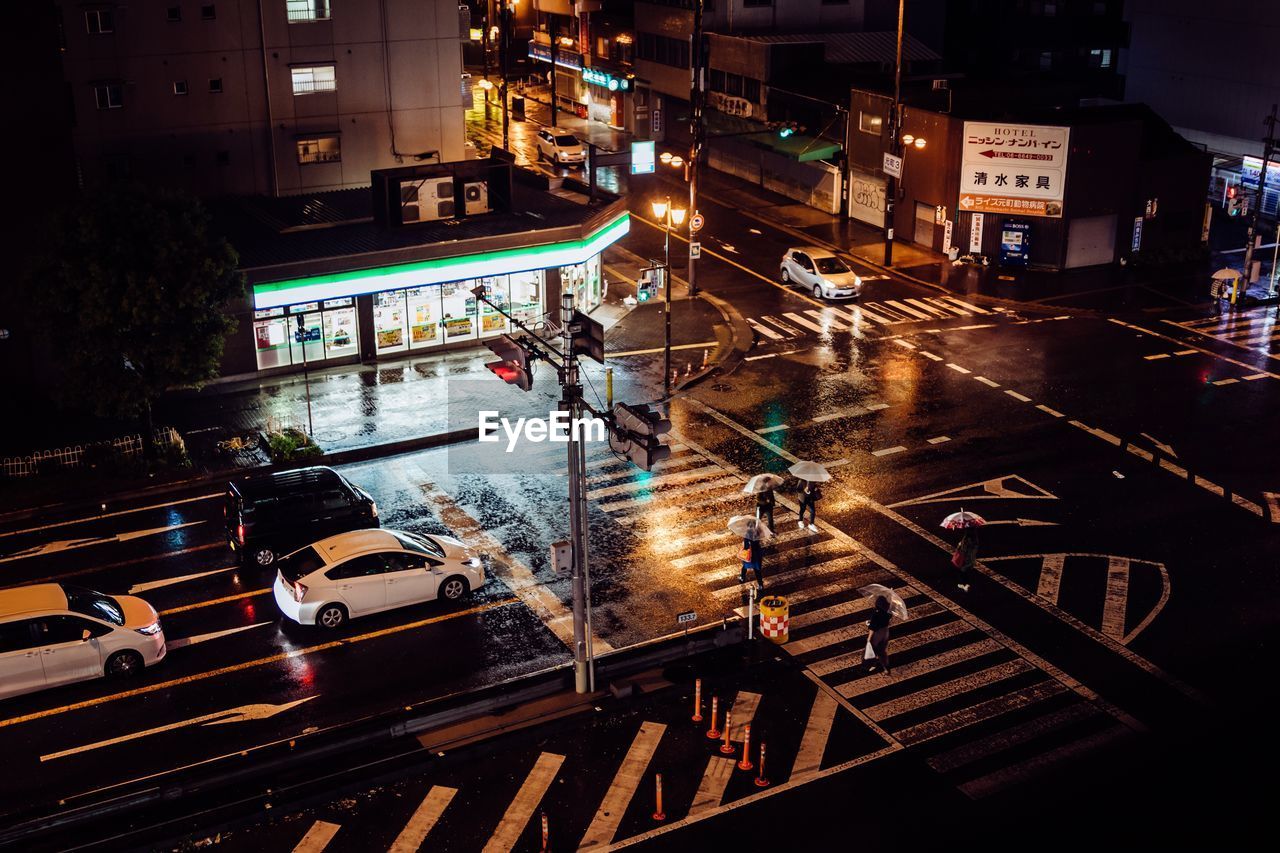 HIGH ANGLE VIEW OF CARS ON ILLUMINATED STREET AT NIGHT