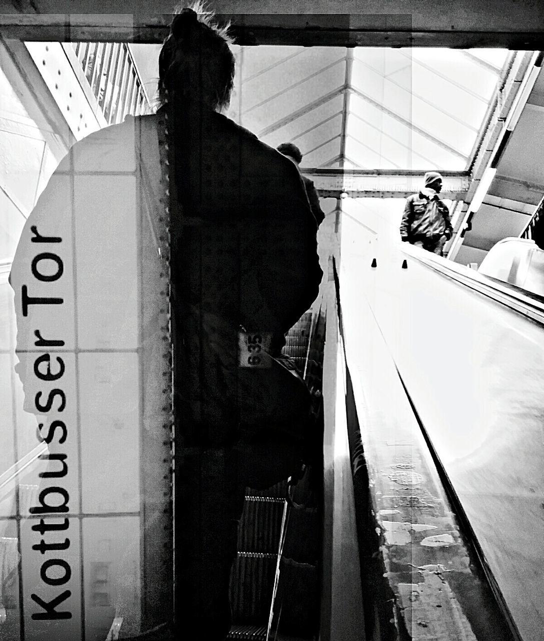 Rear view of people on escalators at railroad station