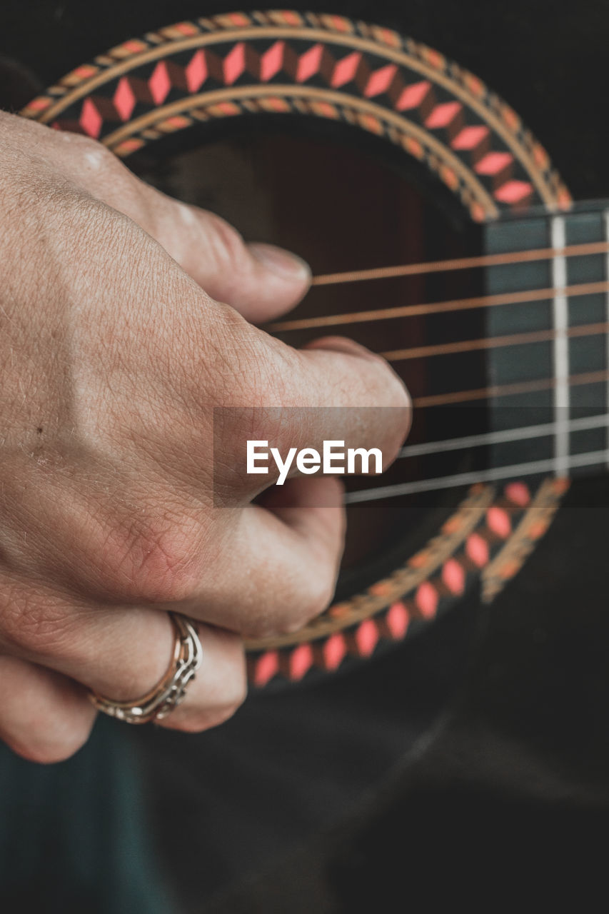 Close-up of man playing guitar