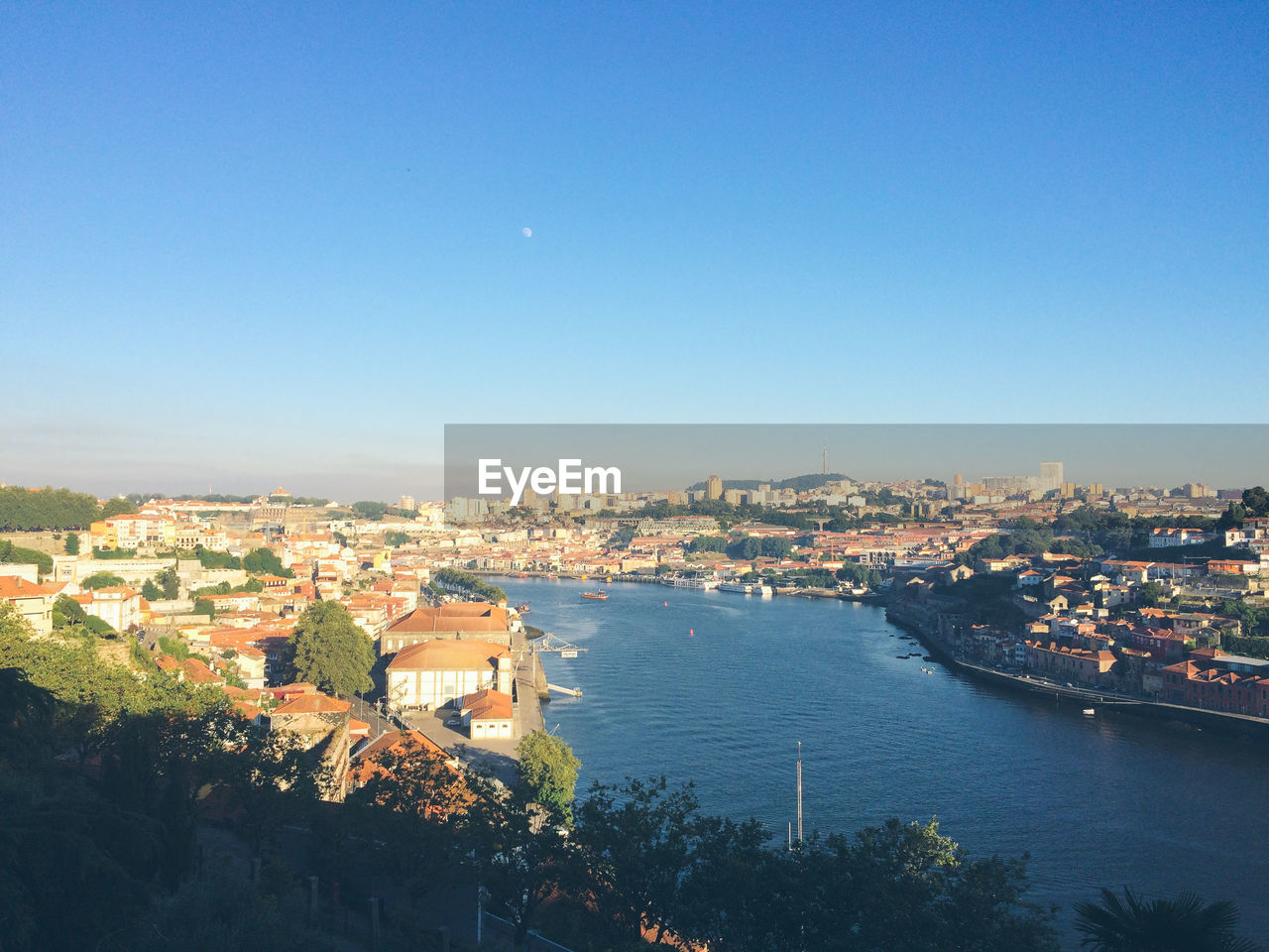 Douro river amidst city against clear blue sky