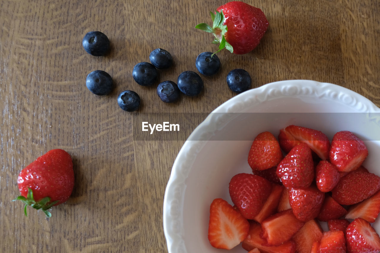 High angle view of strawberries in bowl on table