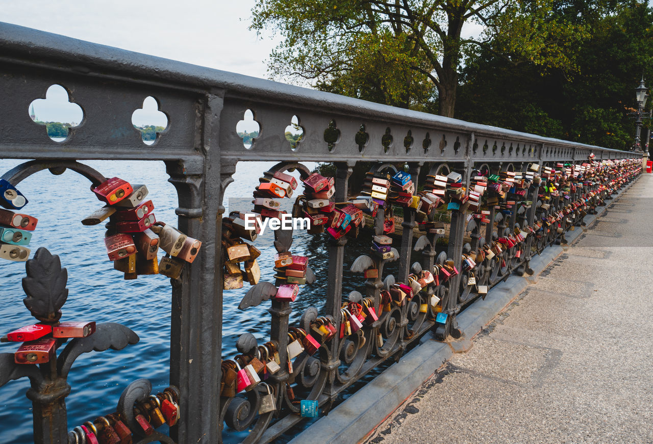 Colorful padlocks on bridge railing