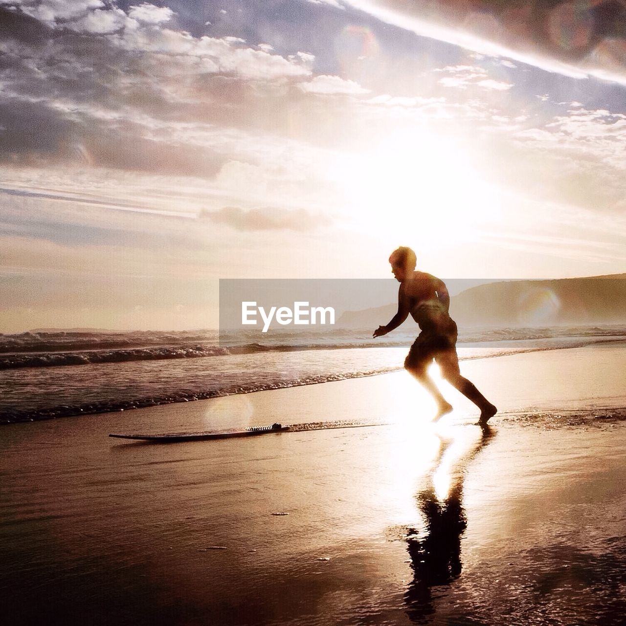 Man playing on beach during sunny day