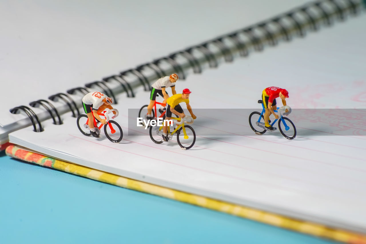 Cycling figurines on book