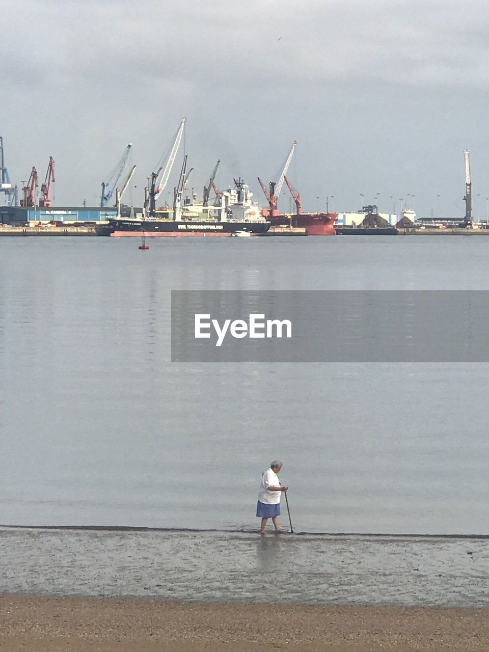 MAN STANDING AT HARBOR