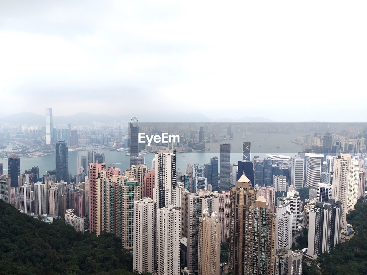 Aerial view of buildings in city against sky