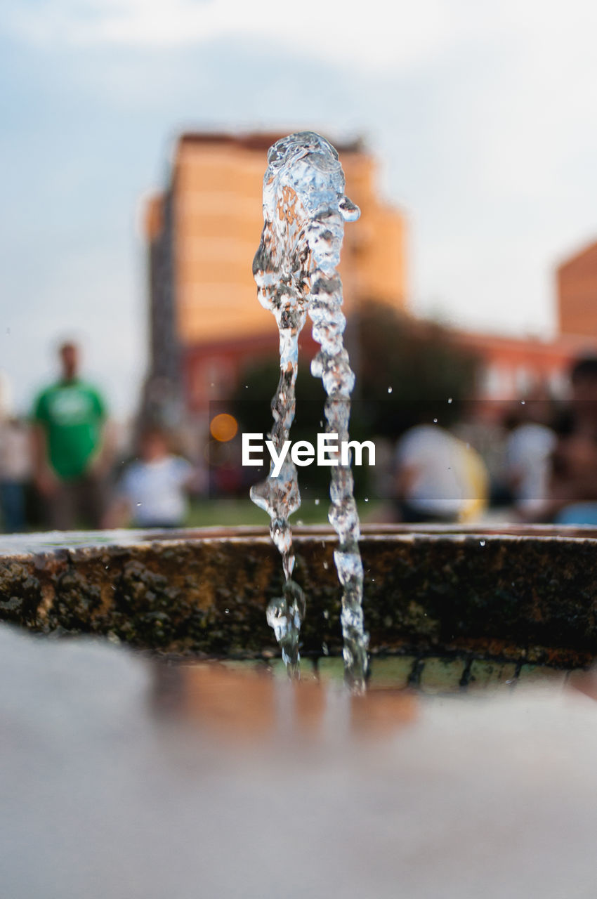 CLOSE-UP OF WATER SPLASHING ON FOUNTAIN