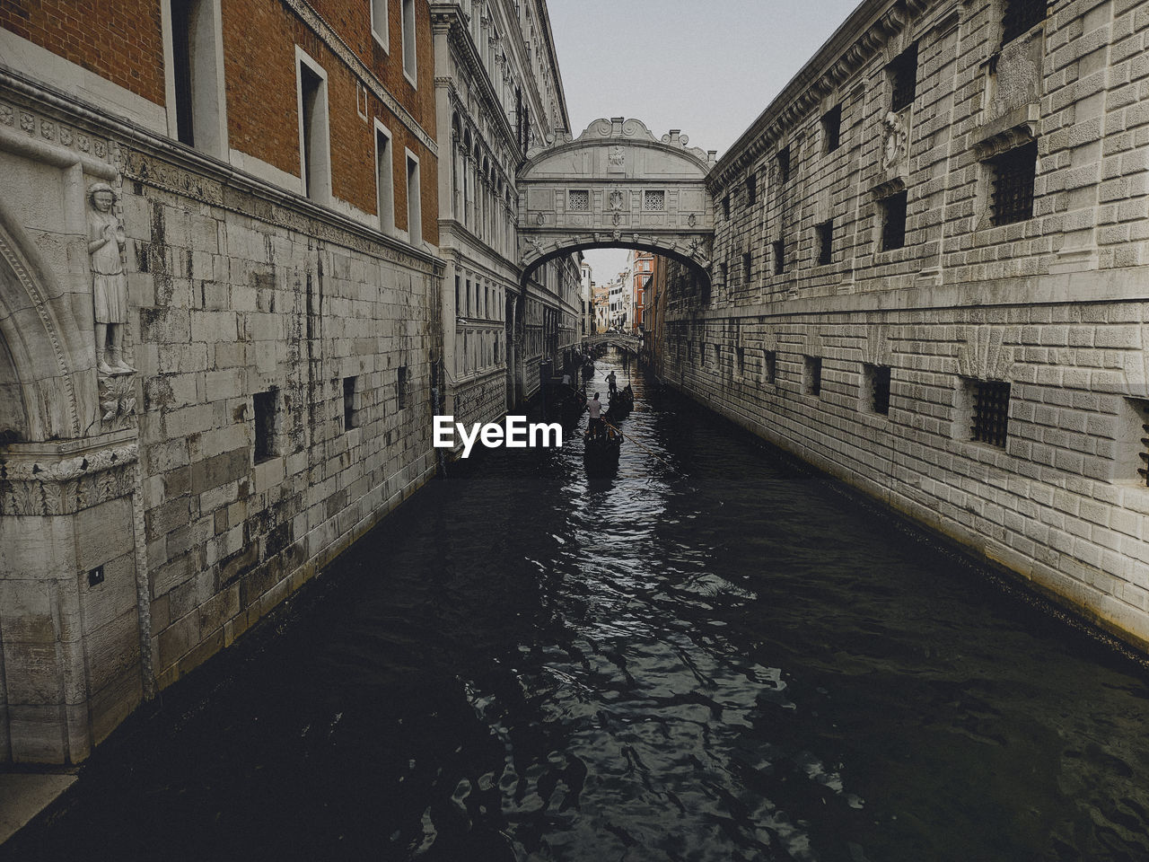 architecture, built structure, building exterior, waterway, water, city, canal, building, travel destinations, one person, nature, reflection, day, bridge, tourism, transportation, travel, men, outdoors, adult, history, street, sky, alley, the past, urban area, wall - building feature, road, walking, wall, arch, lifestyles