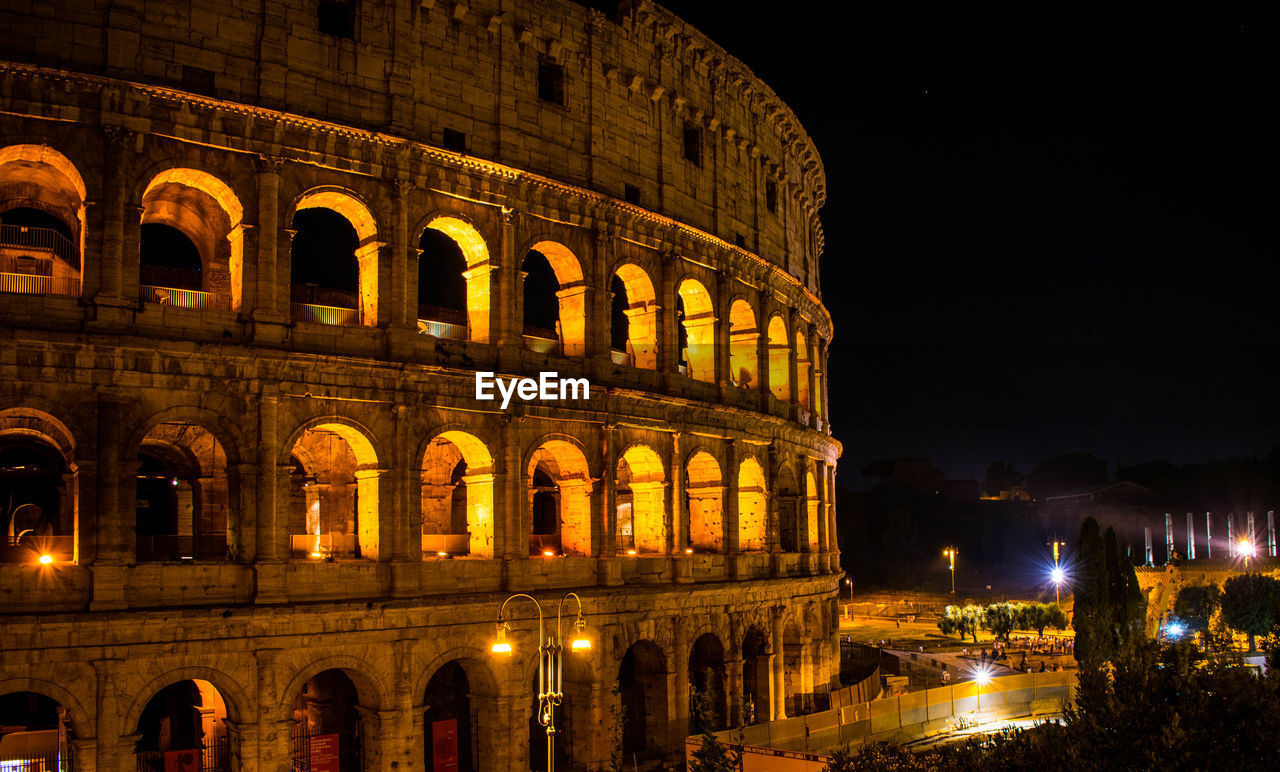 Coliseum against sky at night