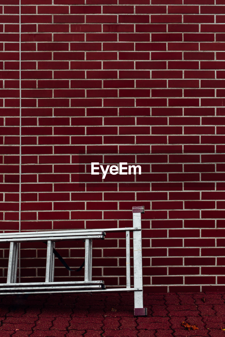 Ladder against brick wall