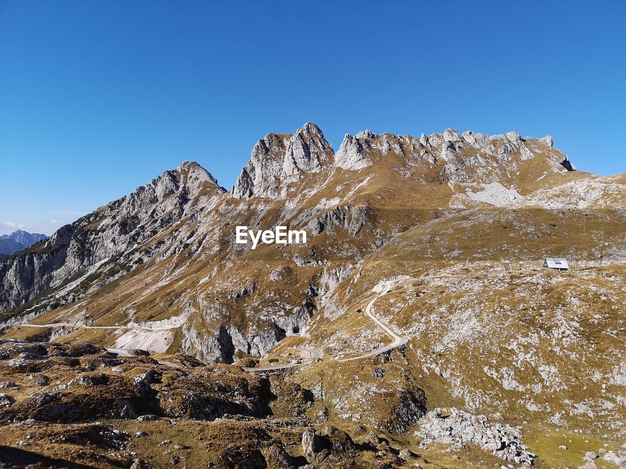 Scenic view of snowcapped mountains against clear blue sky