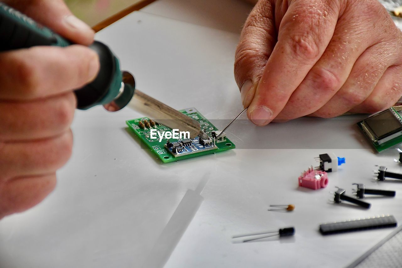 cropped hand of person working on table