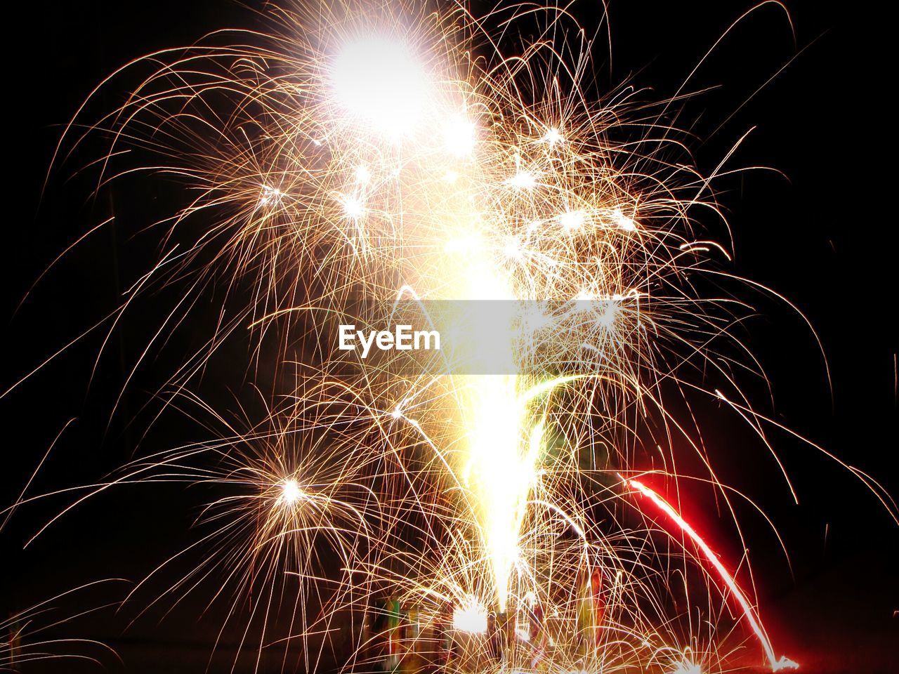 Low angle view of firework display at night