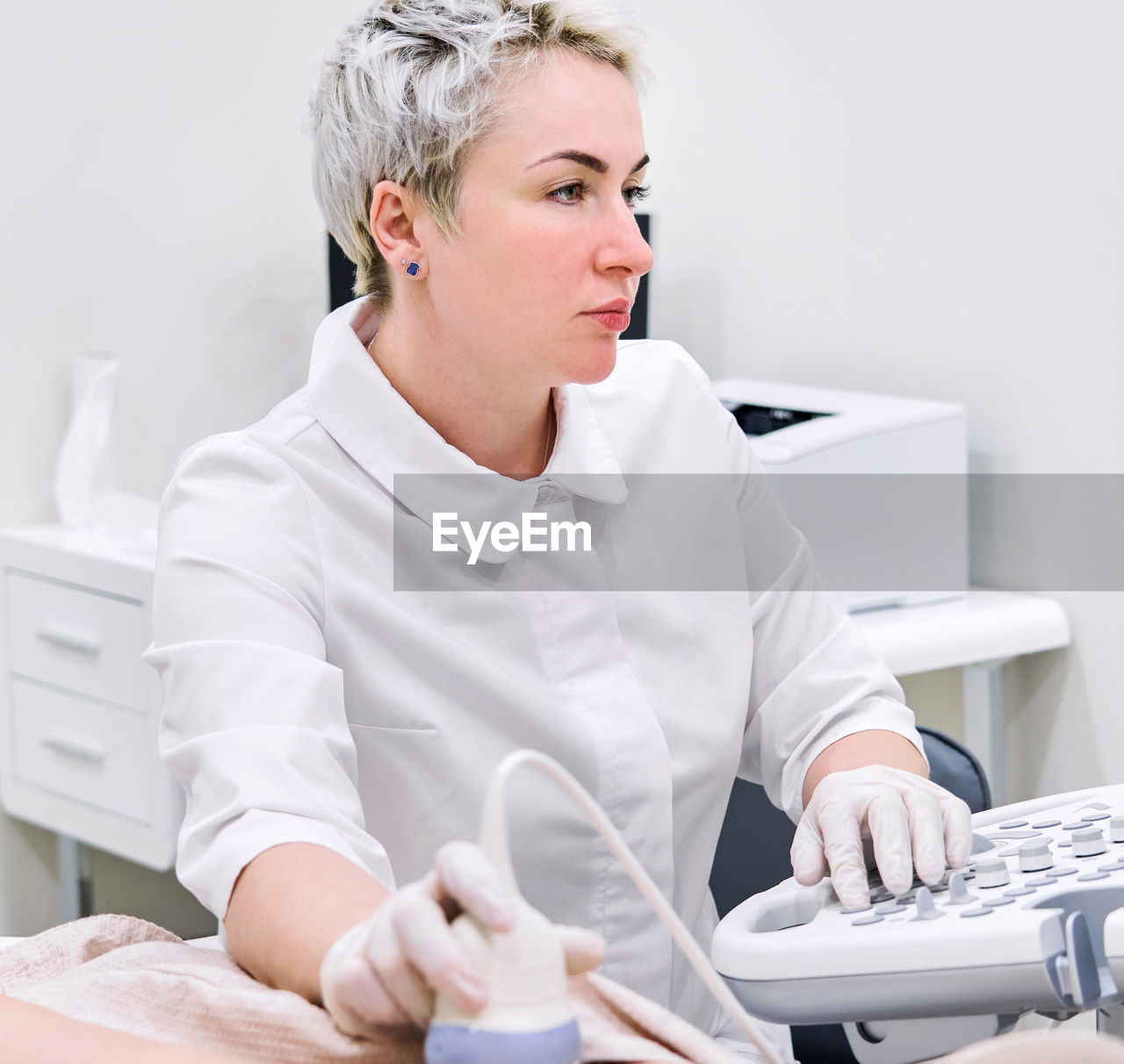 Gynecologist examining patient at hospital