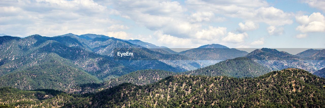 Scenic view of mountains against cloudy sky
