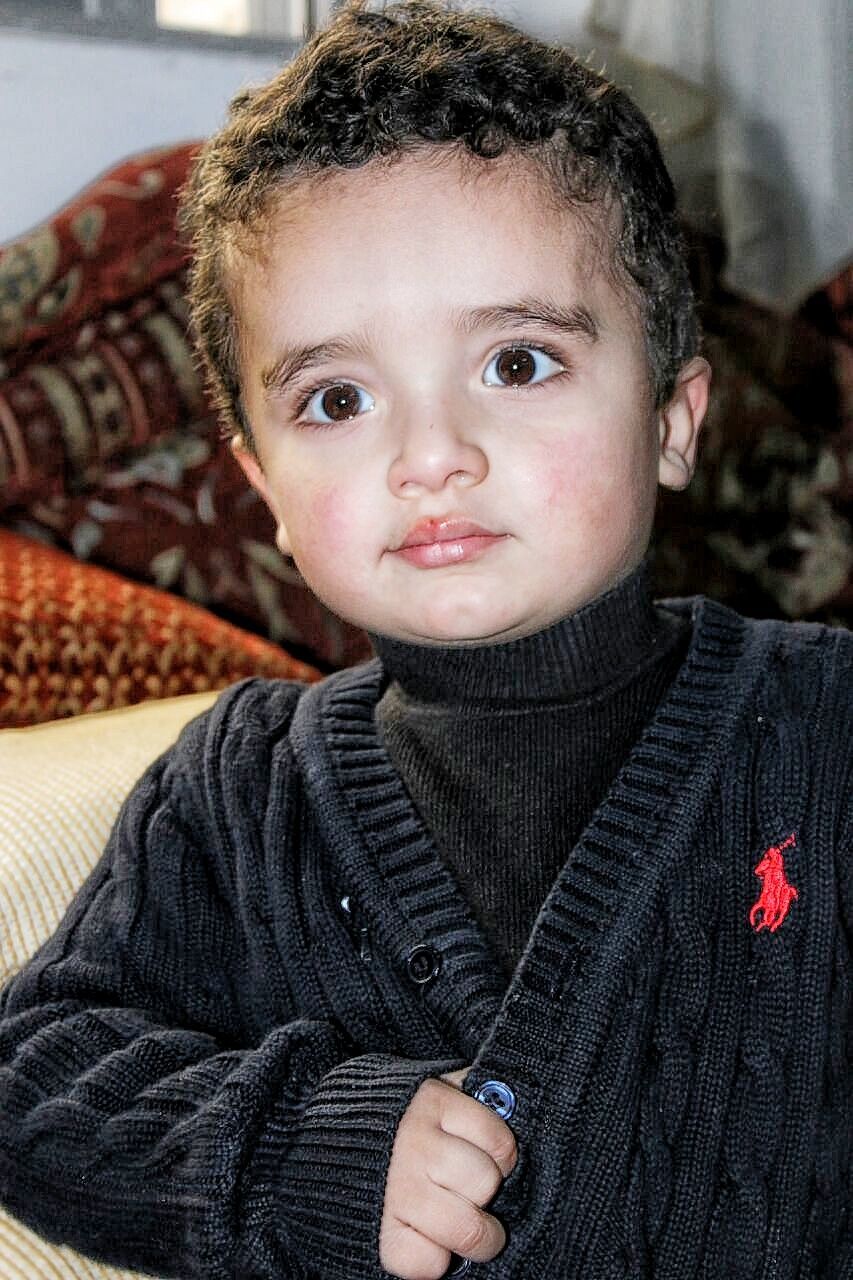 Boy wearing black sweater at home