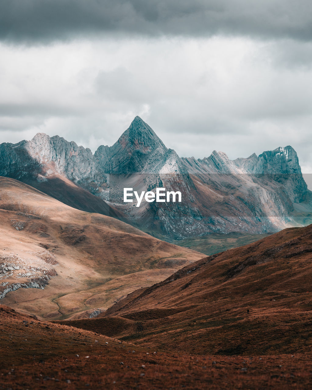 Scenic view of mountains against cloudy sky