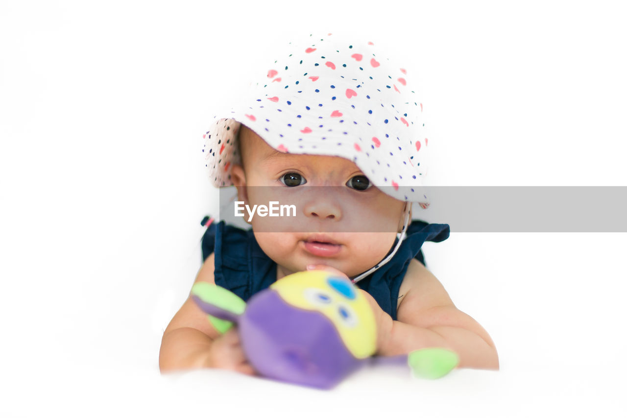 Portrait of baby girl against white background