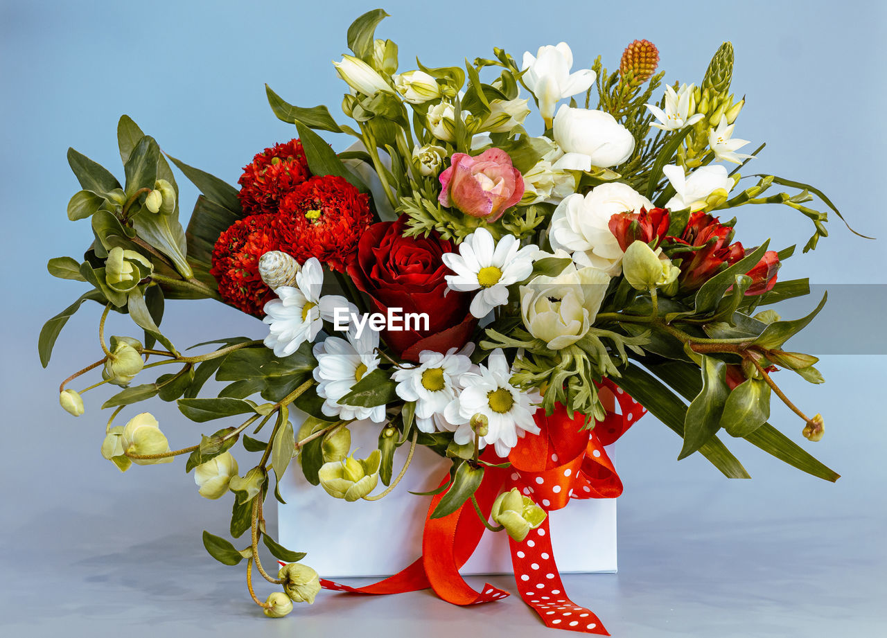 CLOSE-UP OF RED ROSES IN VASE