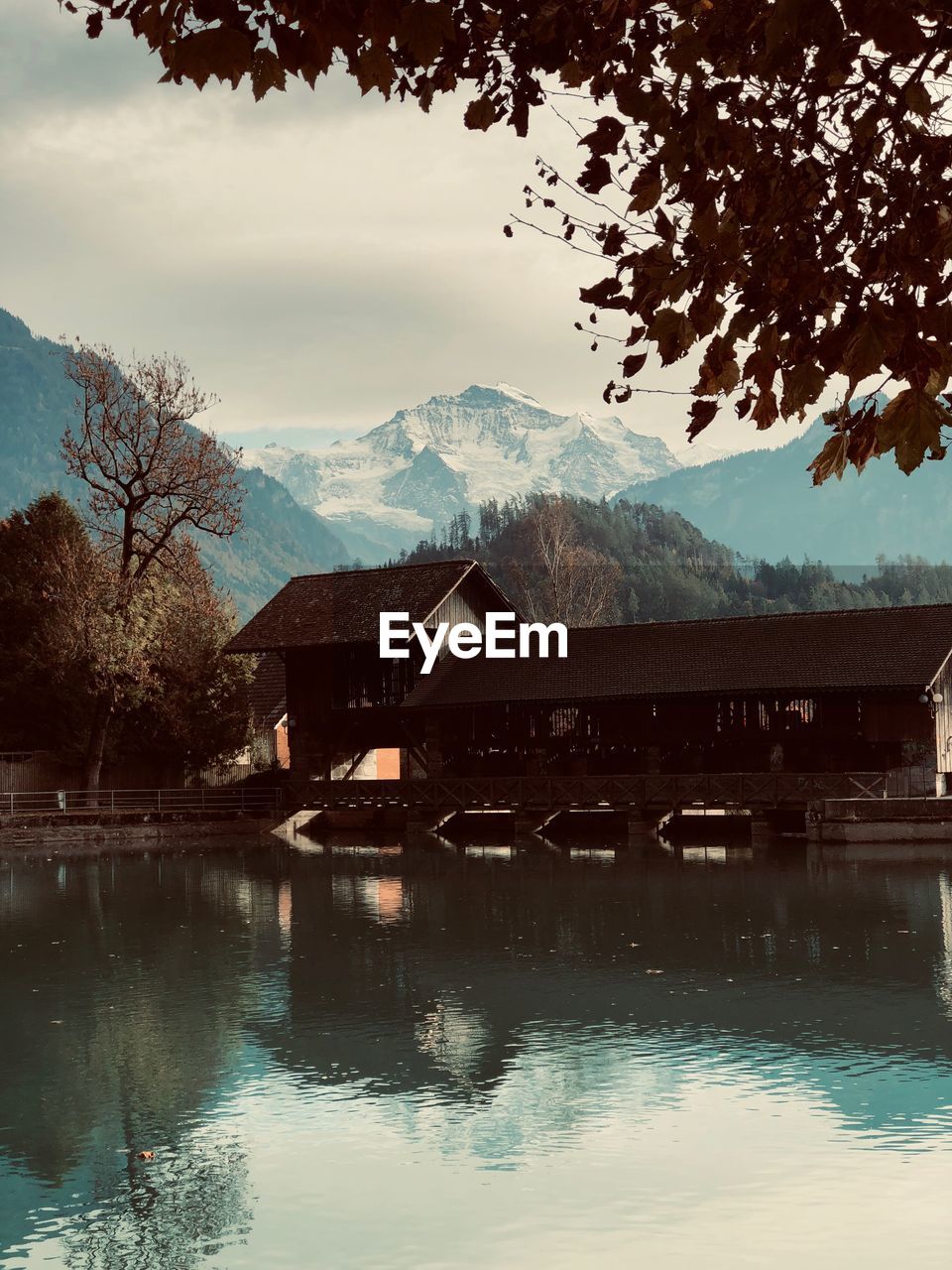 Scenic view of lake by buildings against sky