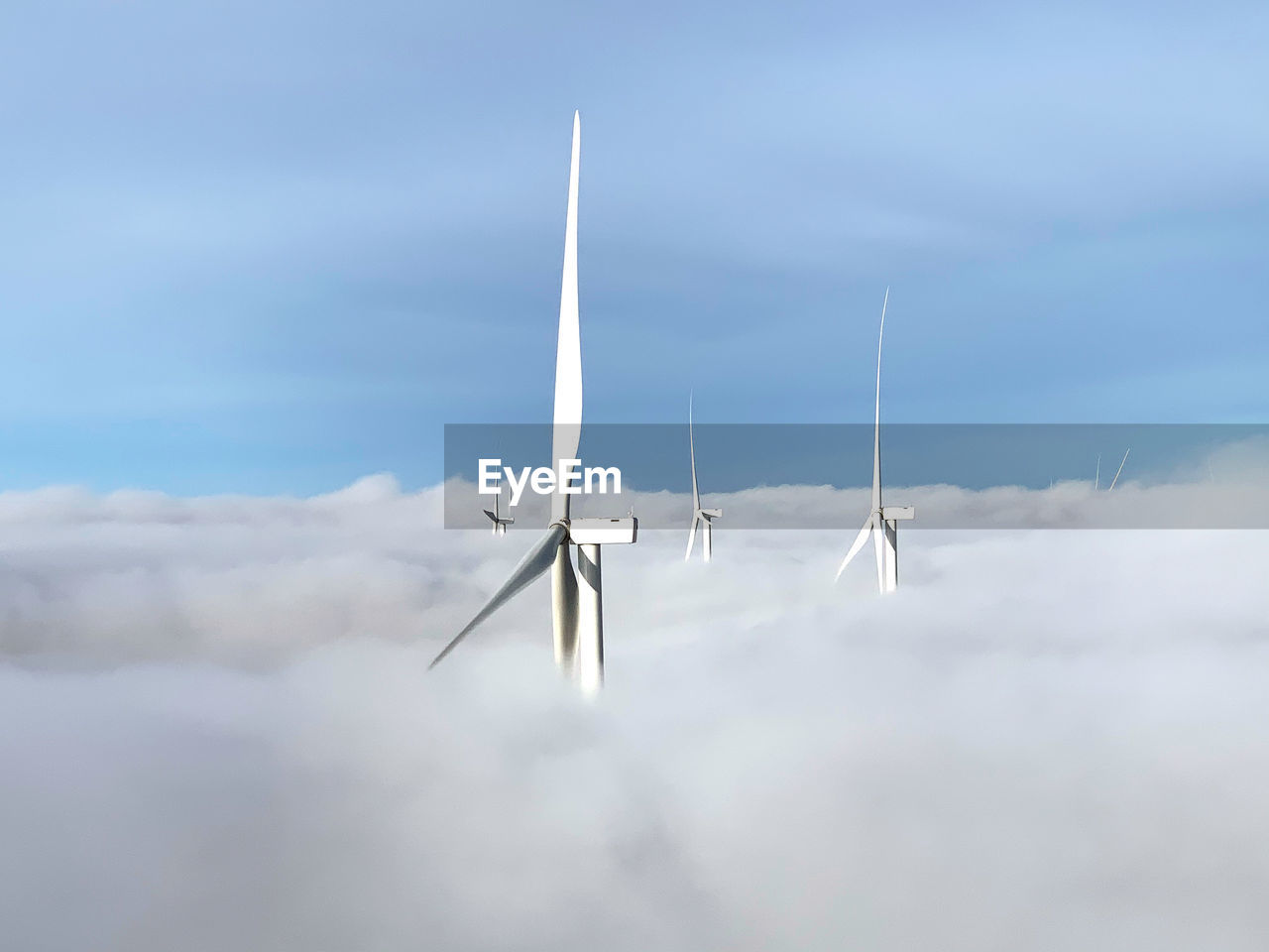 Wind turbine over the clouds