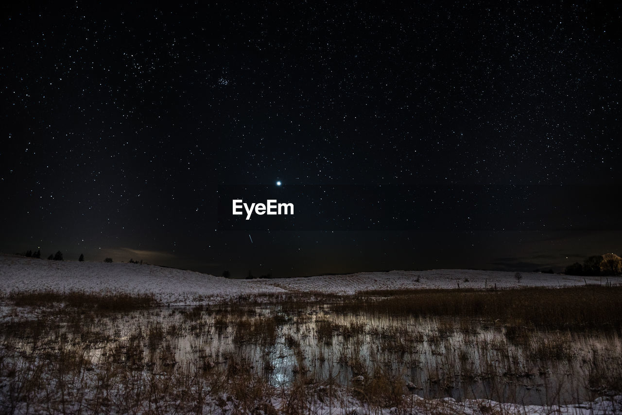 Scenic view of lake against star field at night