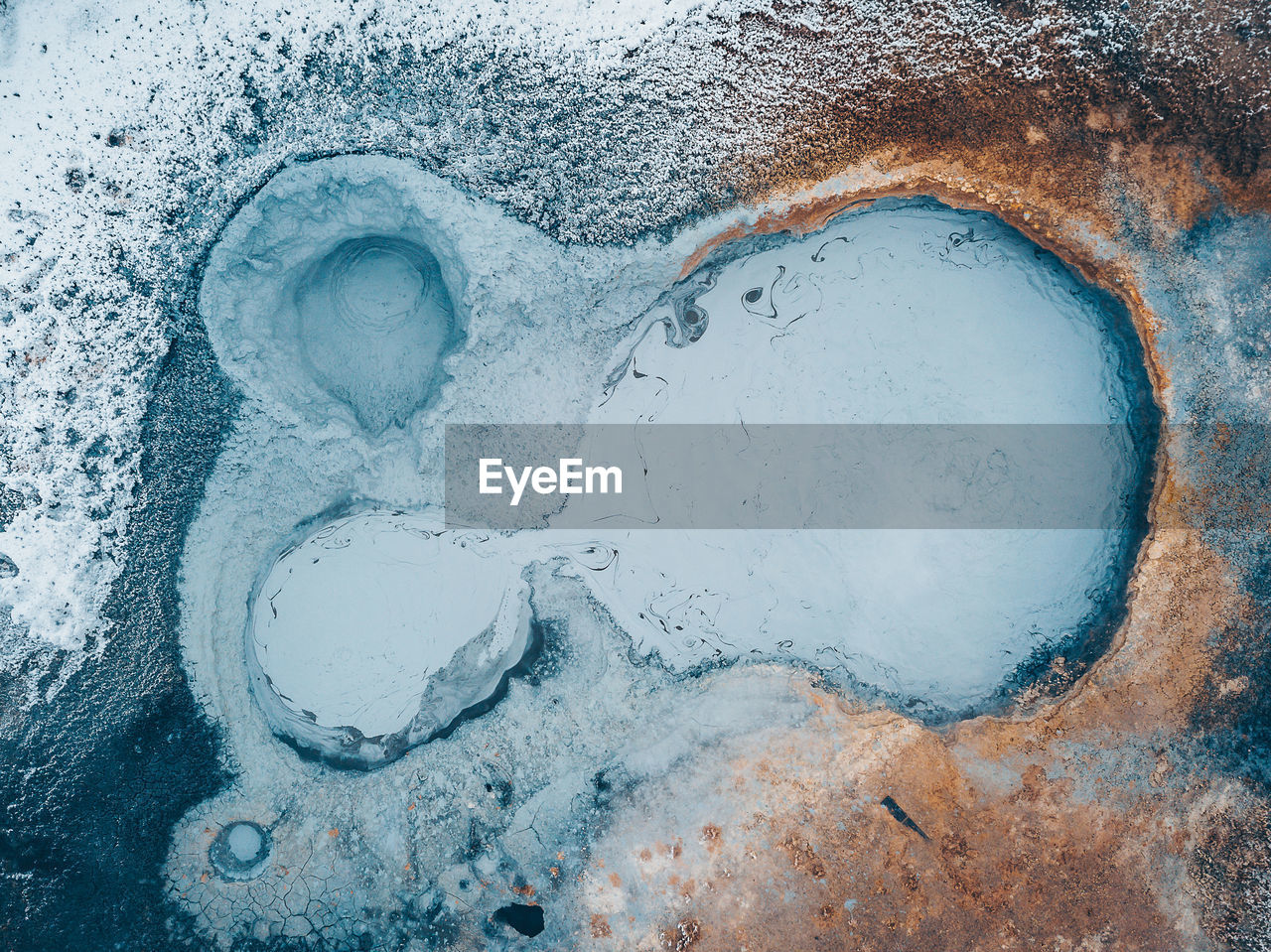 HIGH ANGLE VIEW OF FROZEN WATER ON ICE