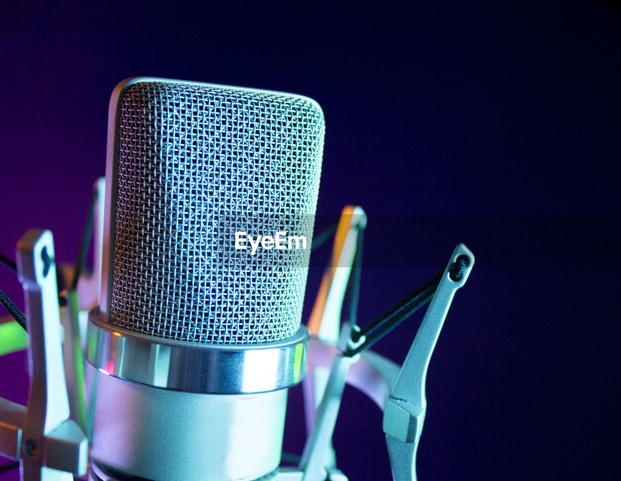 Close-up of microphone against blue background