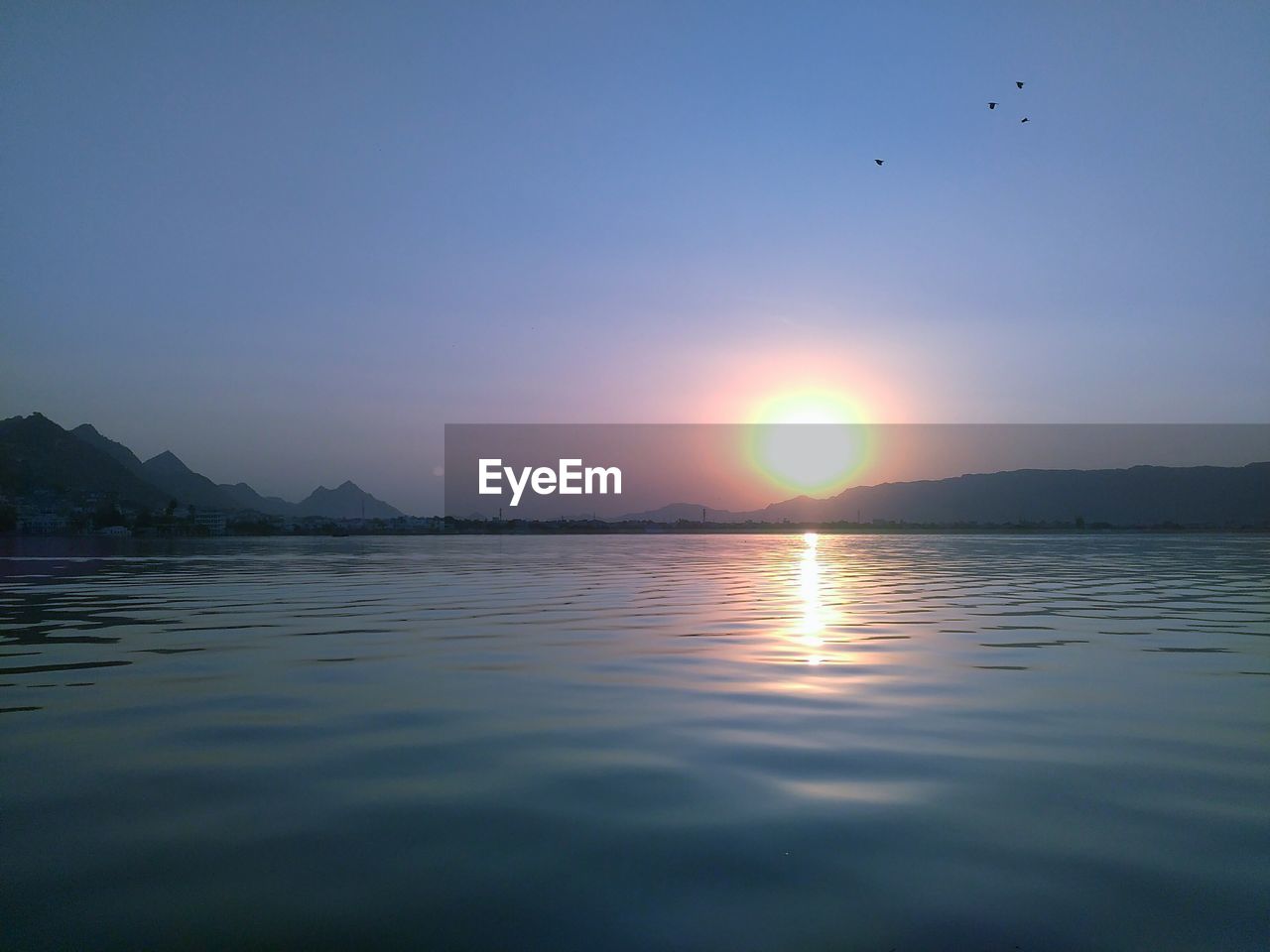 Scenic view of lake at sunset