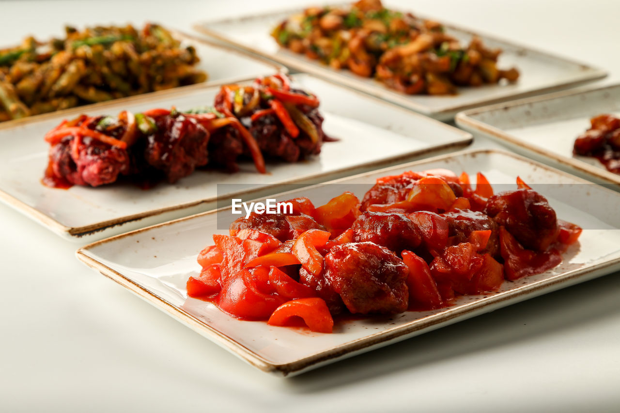 CLOSE-UP OF MEAT AND VEGETABLES ON PLATE