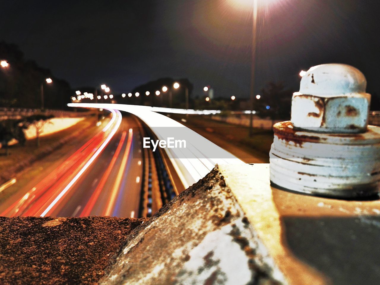 LIGHT TRAILS ON ROAD AT NIGHT