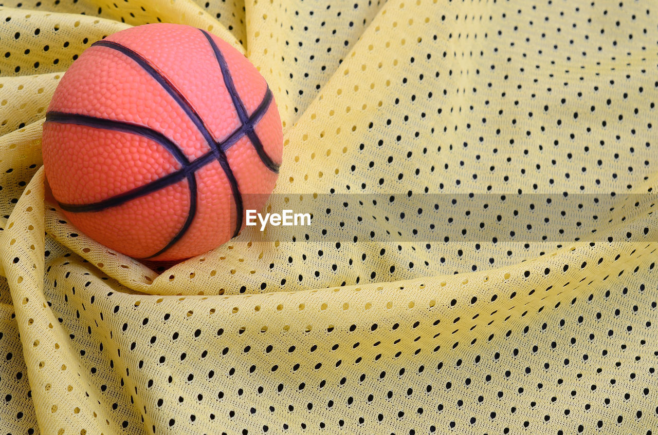 High angle view of basketball on textile