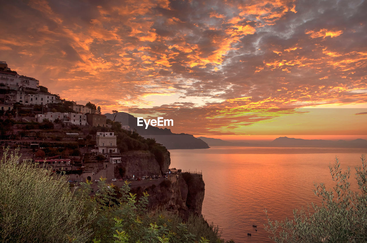 Scenic view of sea and mountains during sunset