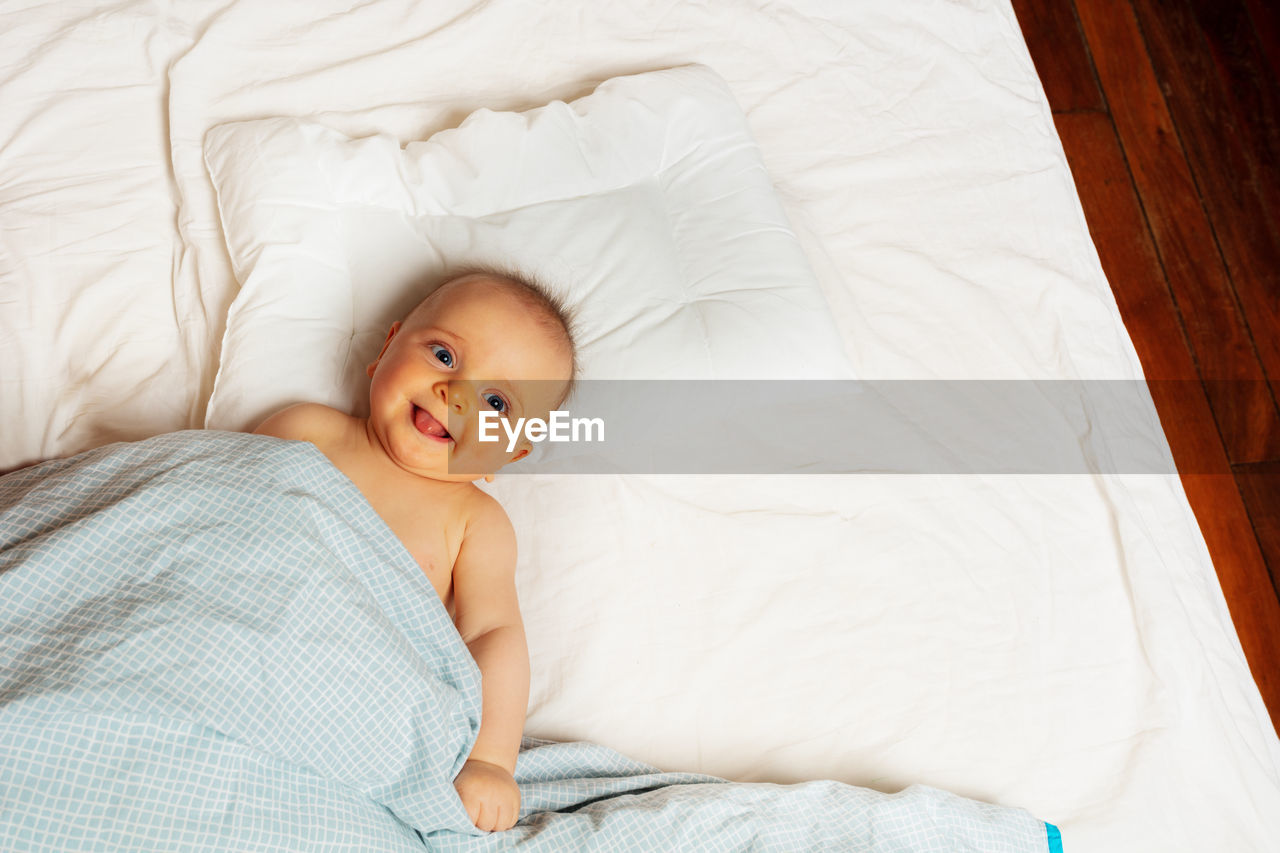 high angle view of baby boy sleeping on bed