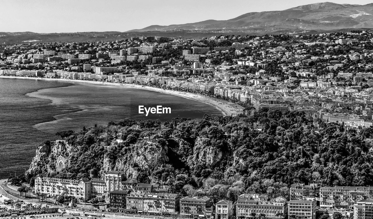 Aerial view of cityscape by sea against sky