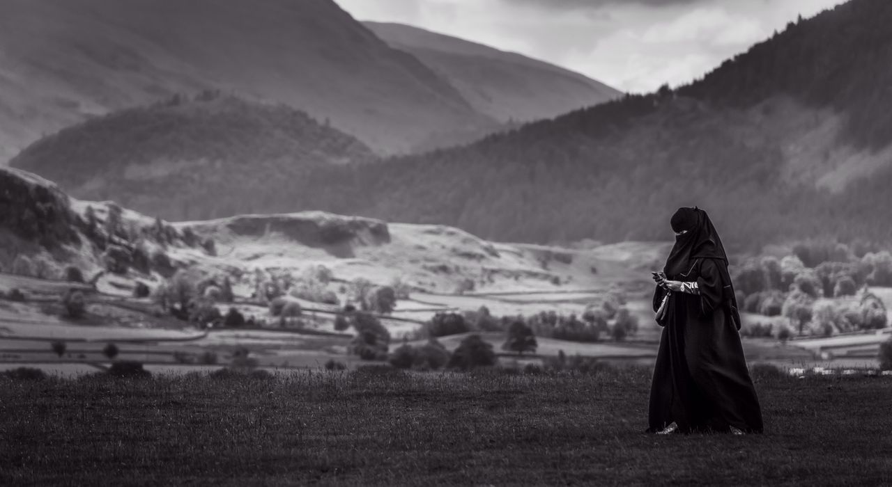 Woman in burka texting