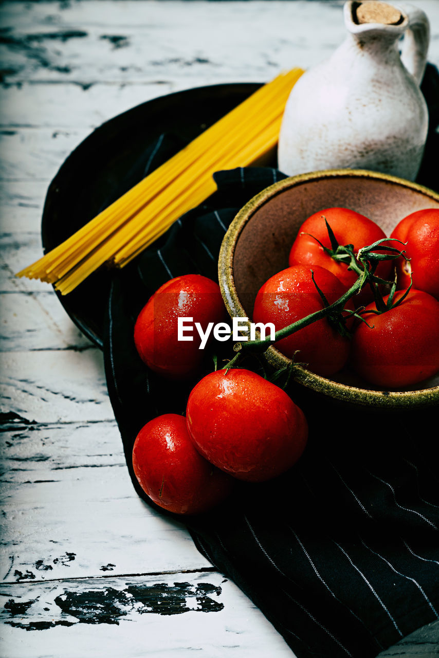 HIGH ANGLE VIEW OF CHERRIES IN CONTAINER ON TABLE