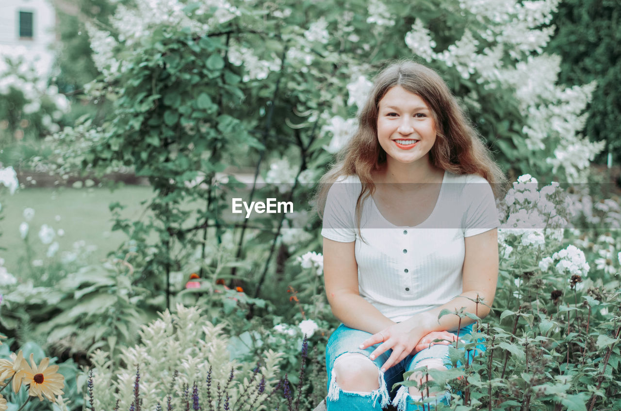 Portrait of smiling girl sitting outdoors